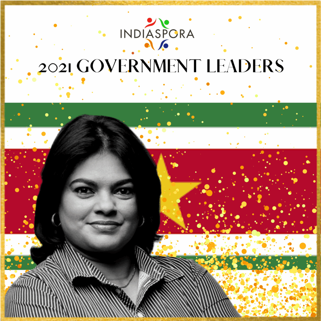 A woman standing in front of an image with the word indiaspora written underneath her.