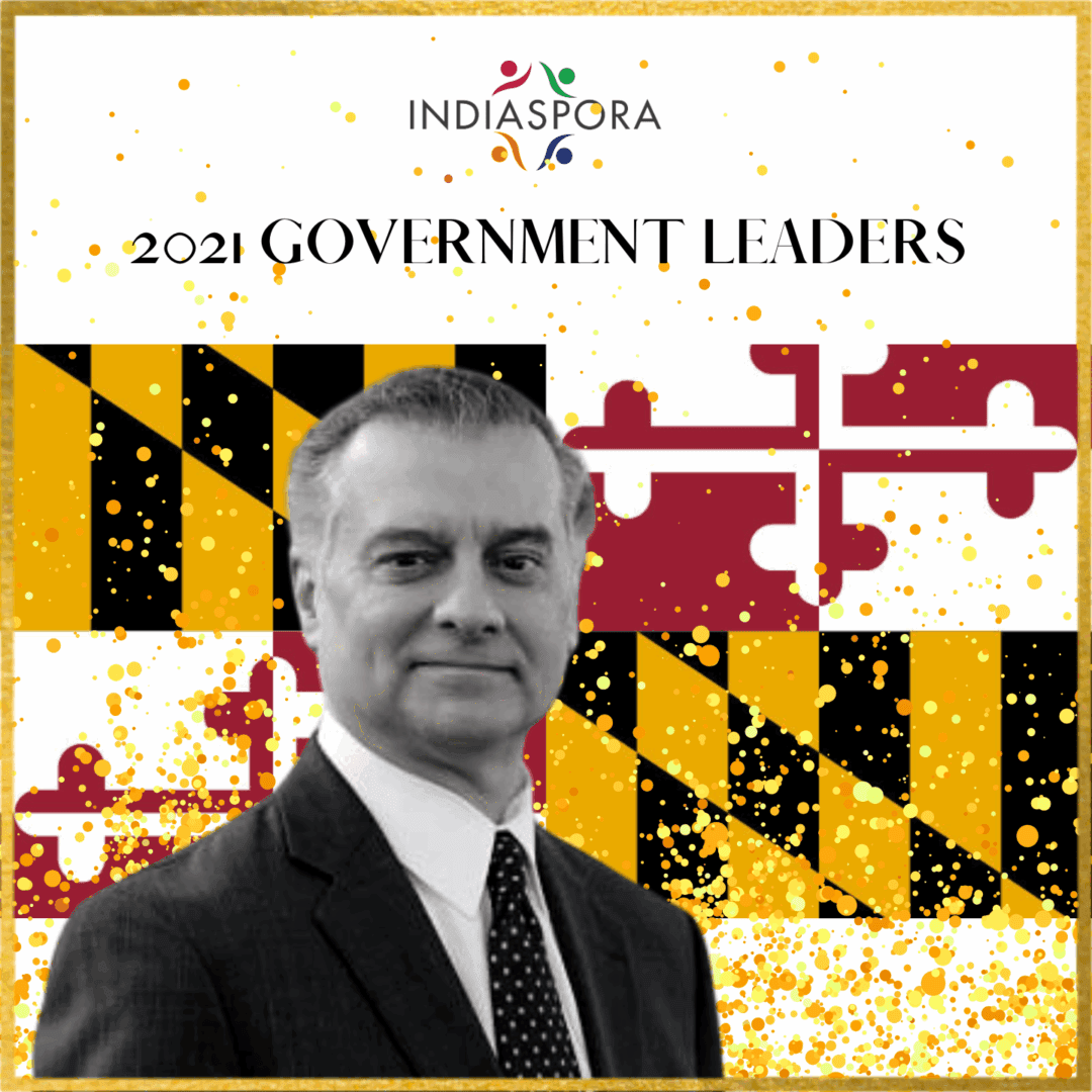 A man in suit and tie standing next to the words " 2 0 2 1 government leaders ".