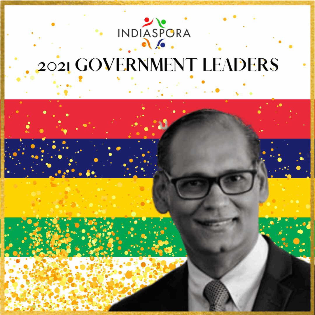 A man in glasses and suit standing next to the words " 2 0 2 1 government leaders ".