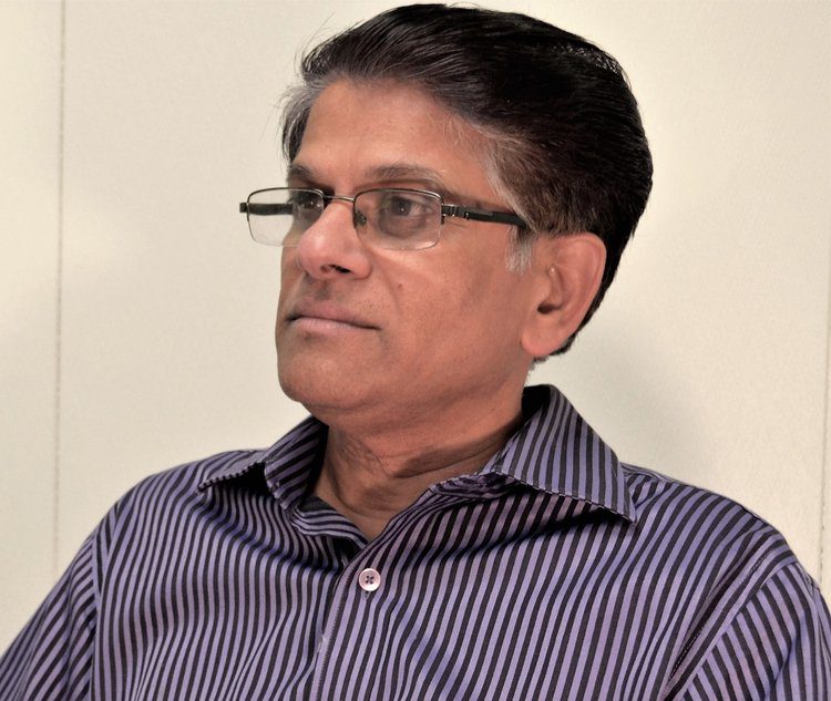 A man with glasses and a striped shirt