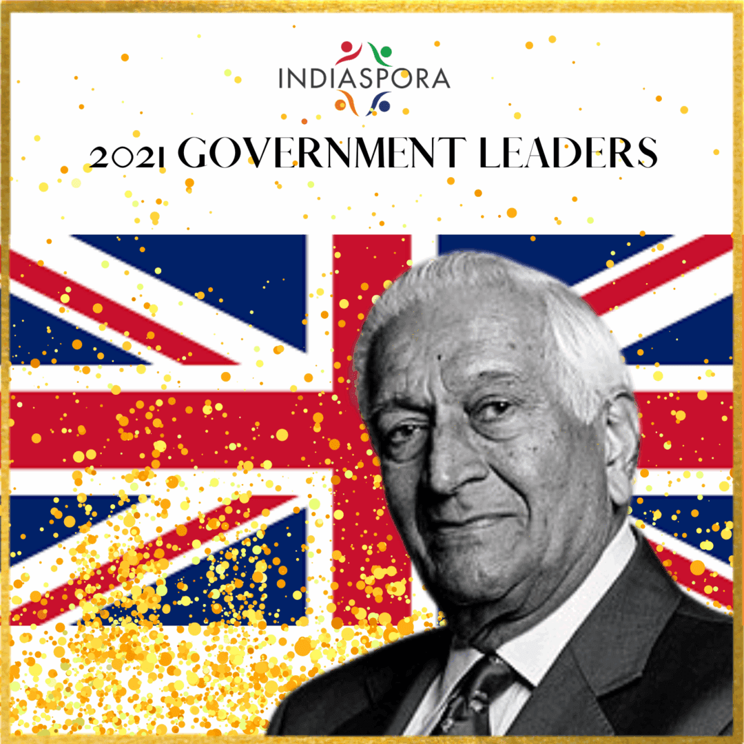 A man in suit and tie with the british flag behind him.