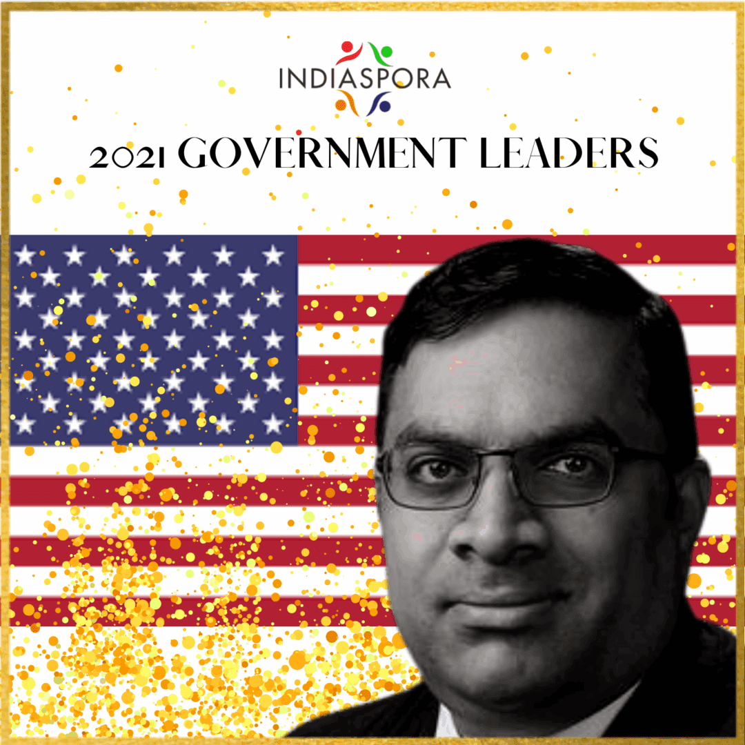 A man with glasses and an american flag background