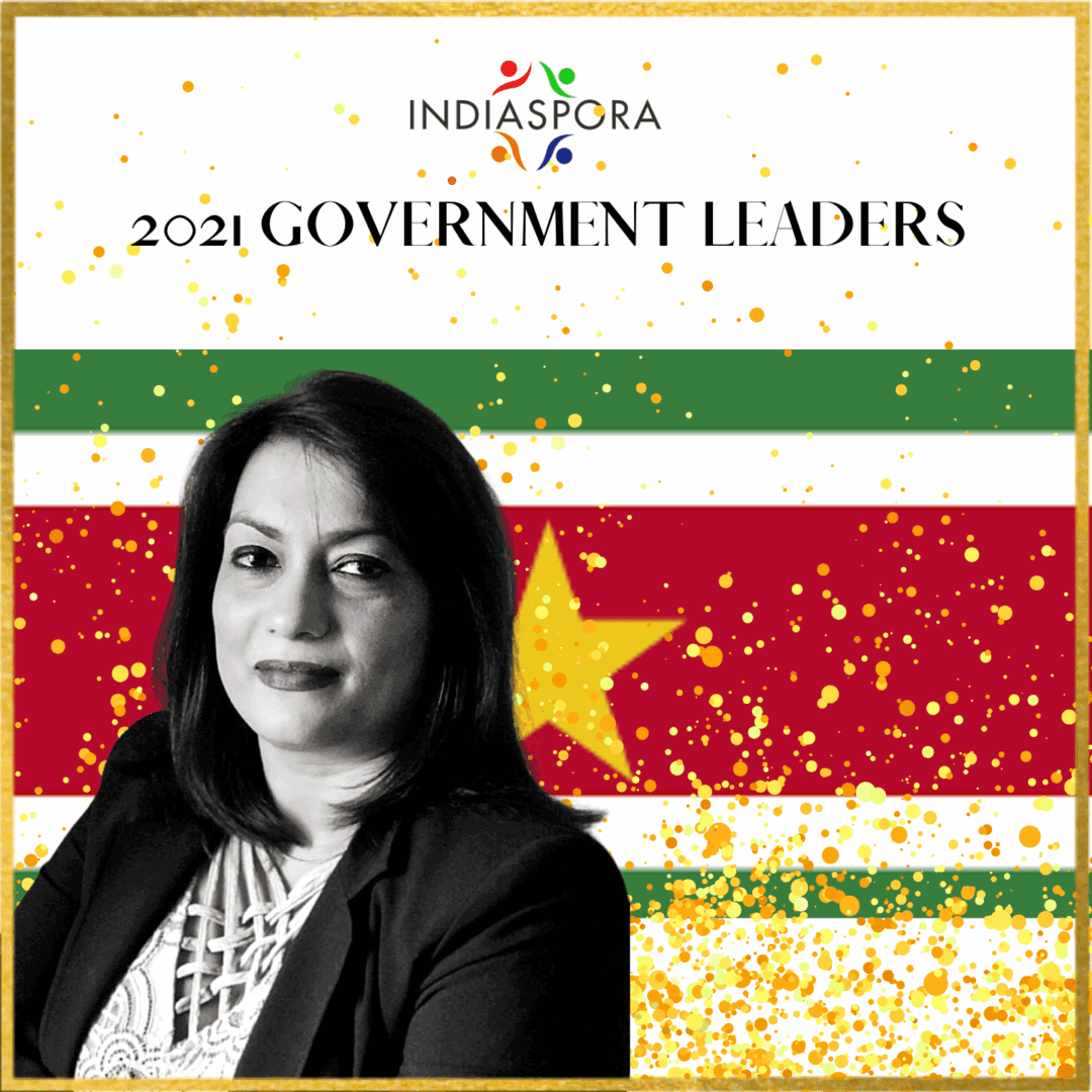 A woman standing in front of an image with the words indiaspora 2 0 2 1 government leaders written underneath her.