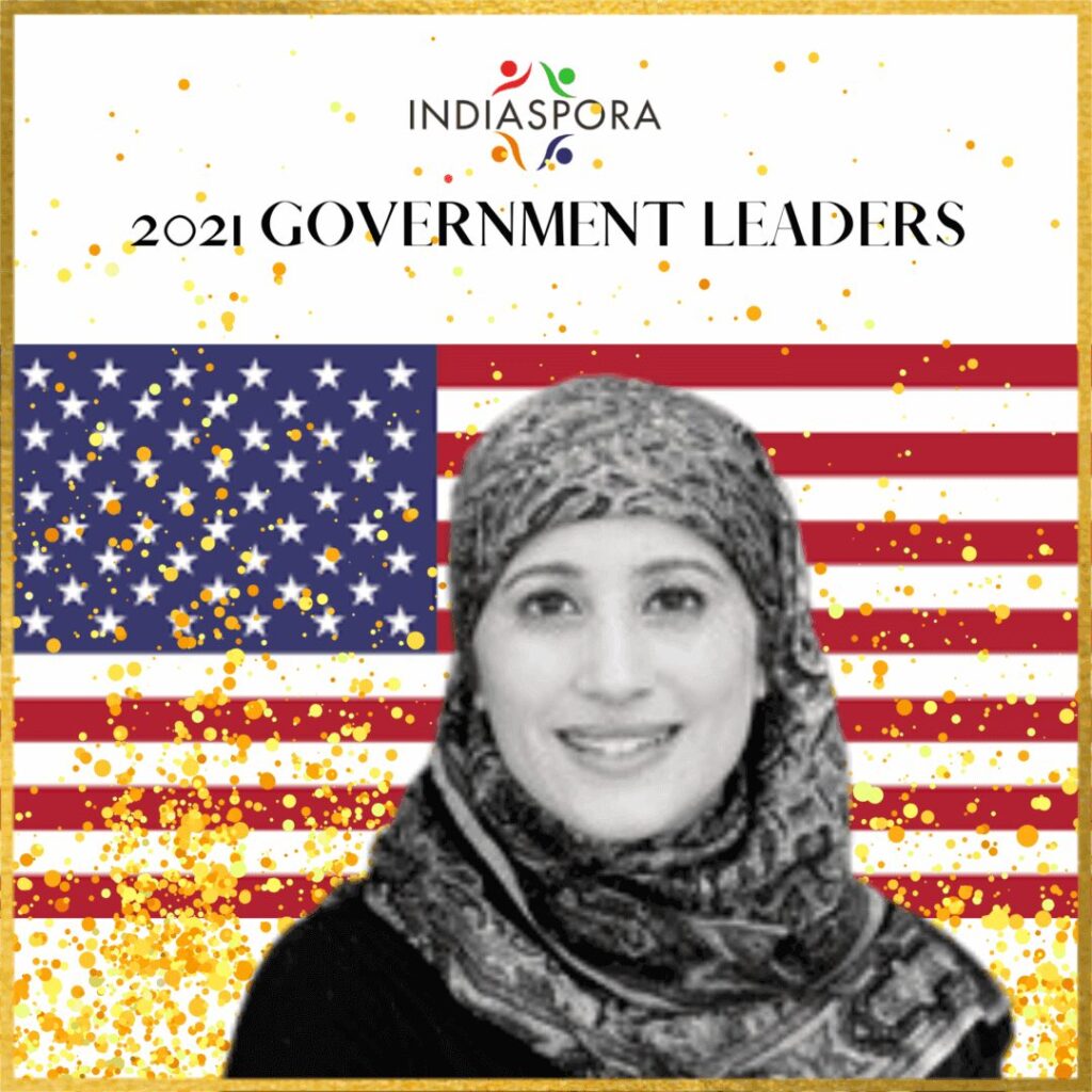 A woman in front of an american flag.