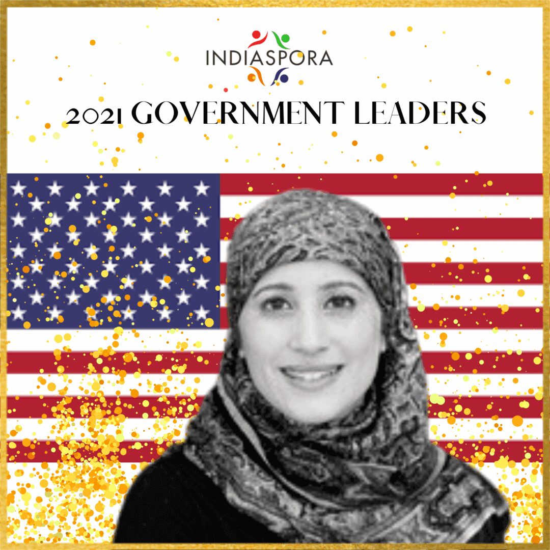 A woman in front of an american flag.