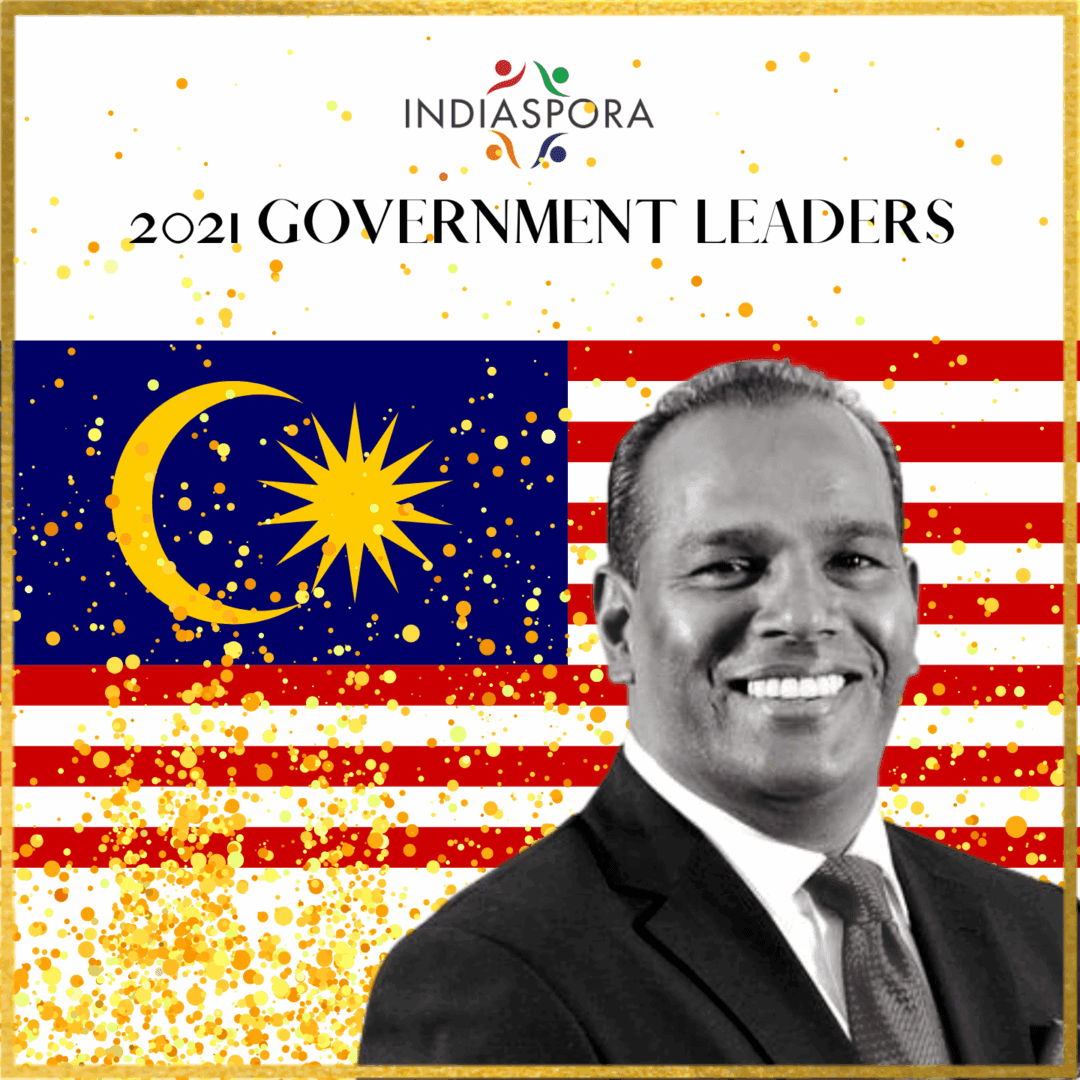 A man in front of the malaysian flag.