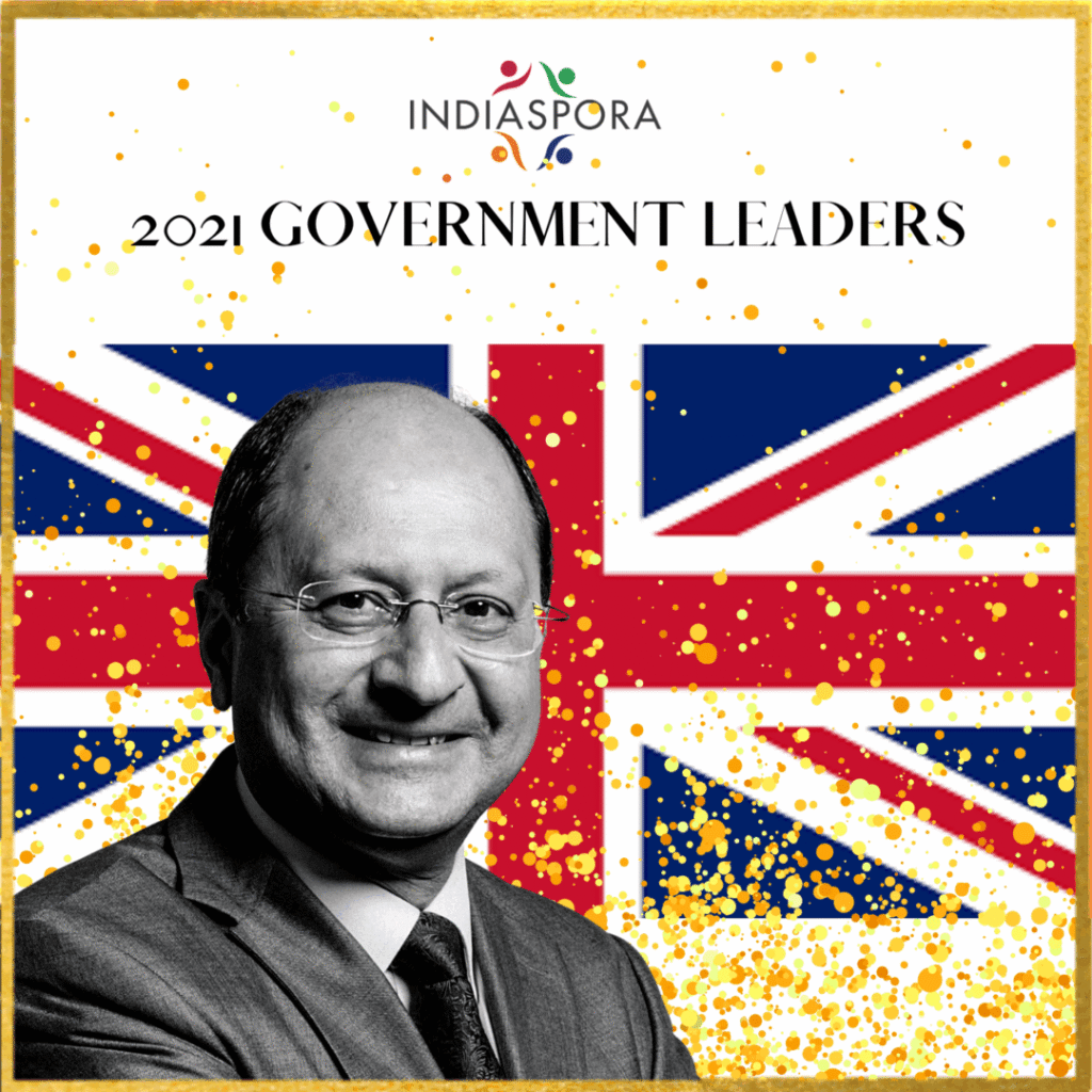A man in suit and tie next to the british flag.