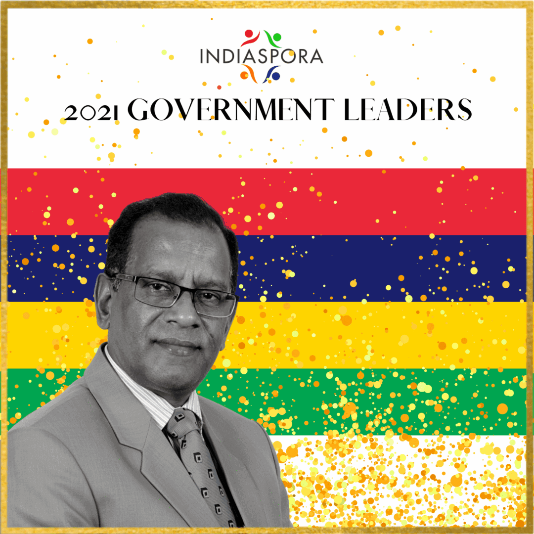 A man in suit and tie standing next to the words " indiaspora 2 0 2 1 government leaders ".