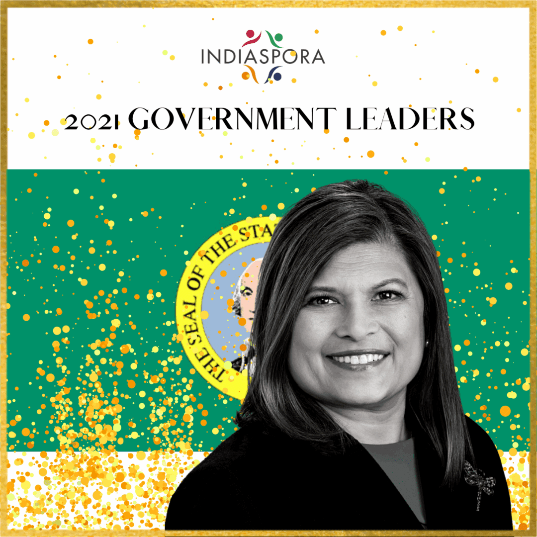 A woman standing in front of the state flag.