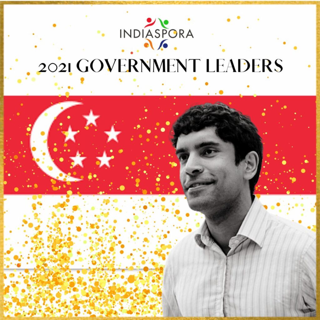 A man standing in front of an singapore flag.