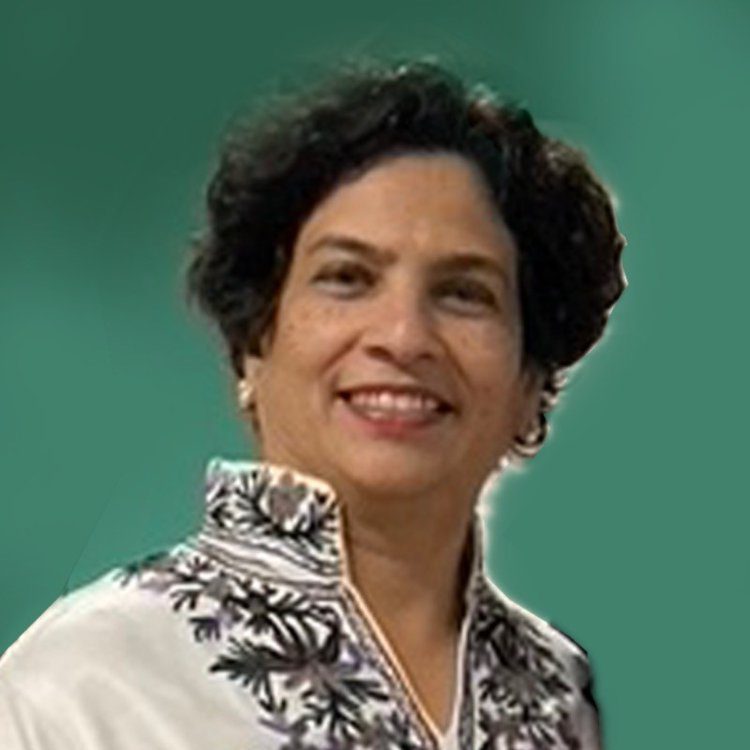 A woman in white shirt and black floral print jacket.